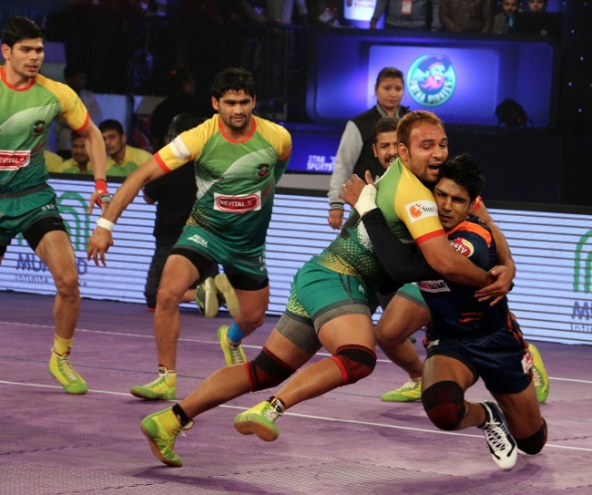 Sunil of Patna Pirates trying to stall Shrikant Jadhav's march into his own half with a front tackle in the Star Sports Pro Kabaddi season 3 in Patna
