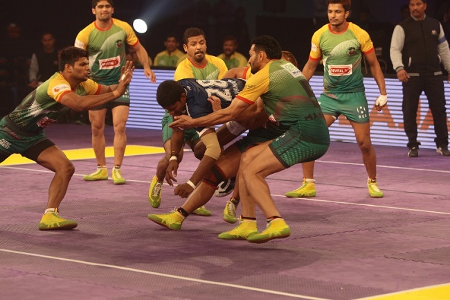Selvamani of Dabang Delhi K.C. being tackled by the Patna Pirates captain Manpreet Singh and Sunil as Amit Hooda closes in, in match 23 of the Star Sports Pro Kabaddi season 3 in Pune