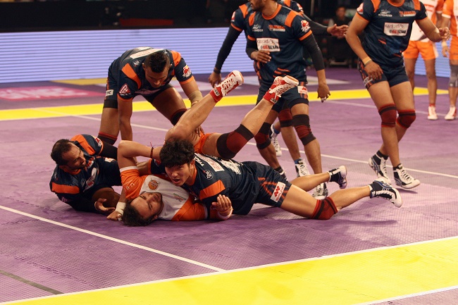 Captain of the Puneri Paltan Manjeet Chhillar is piled onto by the defense of the Bengal Warriors in the Star Sport Pro Kabaddi season 3 in Mumbai